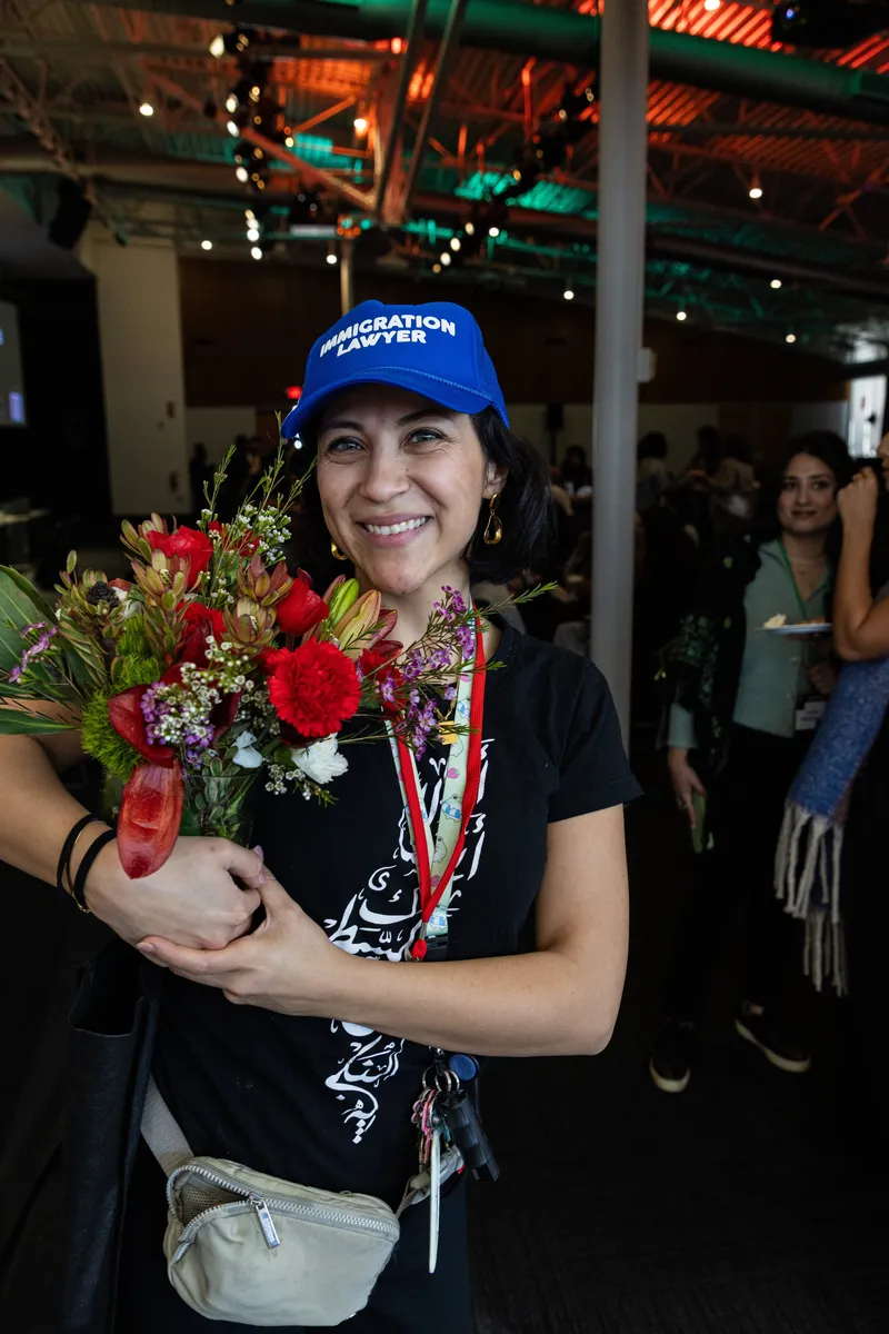 Immigration lawyer holding flowers at a Tech for Palestine event